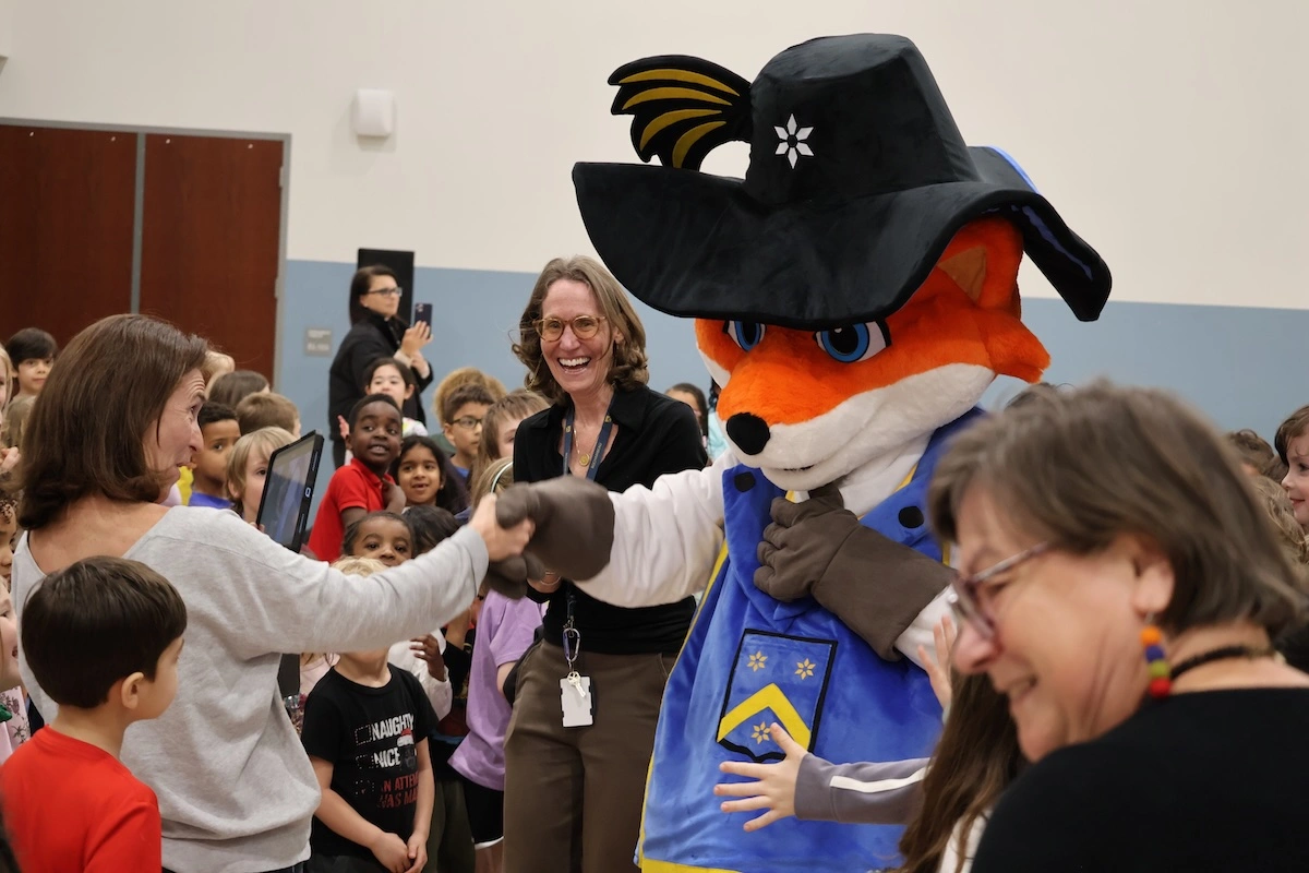 Rochembeau mascot character interacting with students