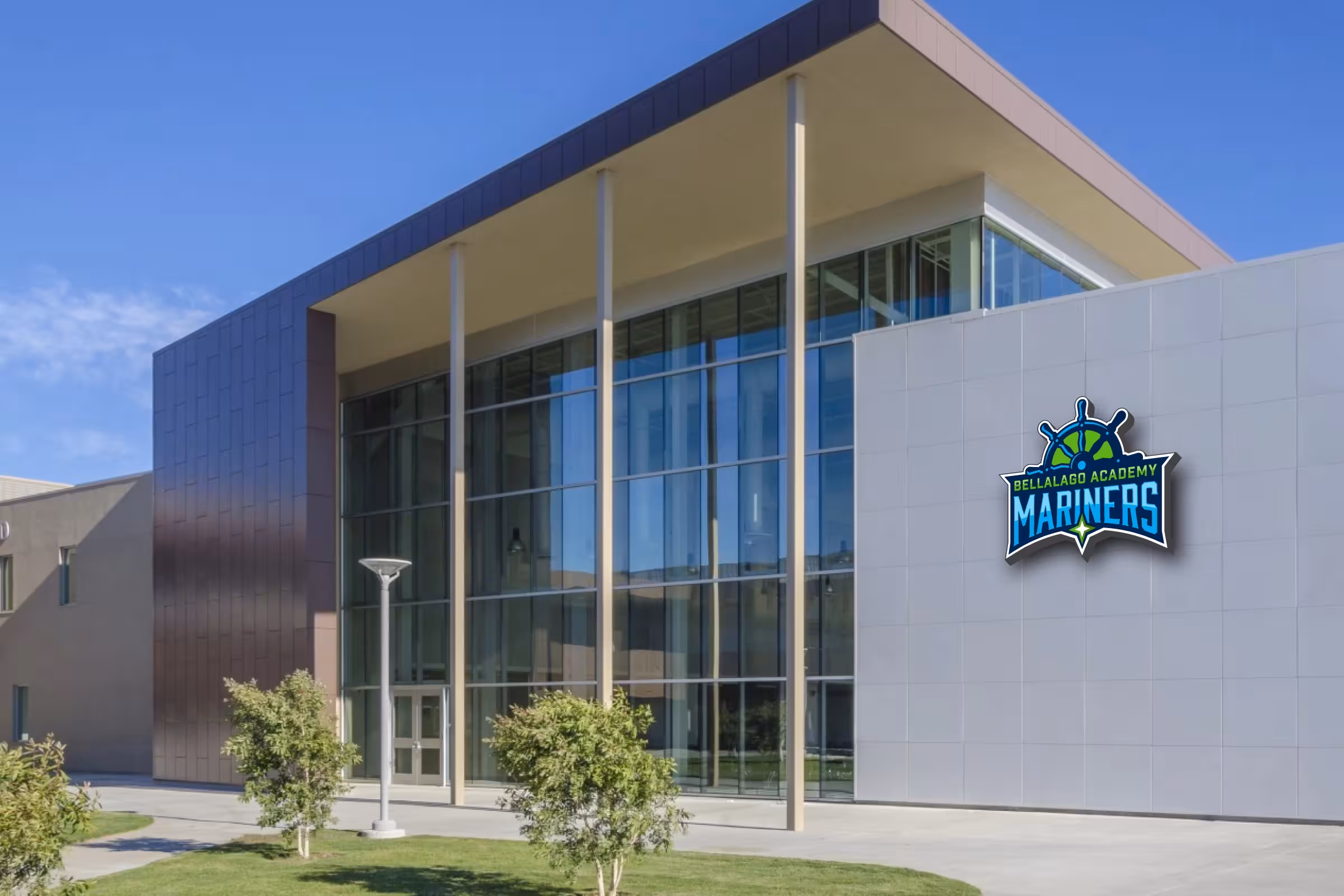 Modern campus facade with mounted Mariners crest—architectural identification at main entry