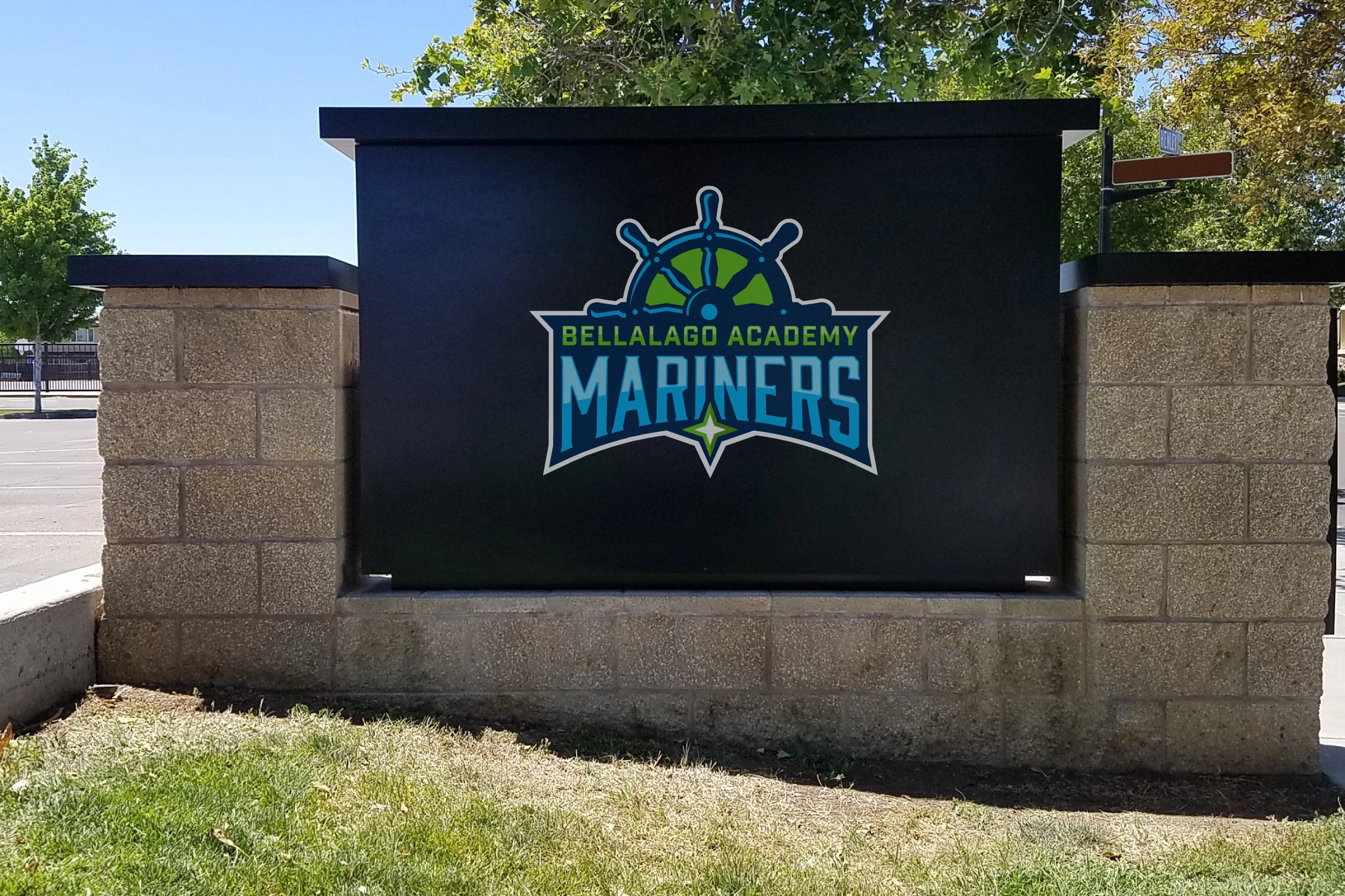 Monument sign with Mariners badge—high‑contrast black panel for drive‑by visibility