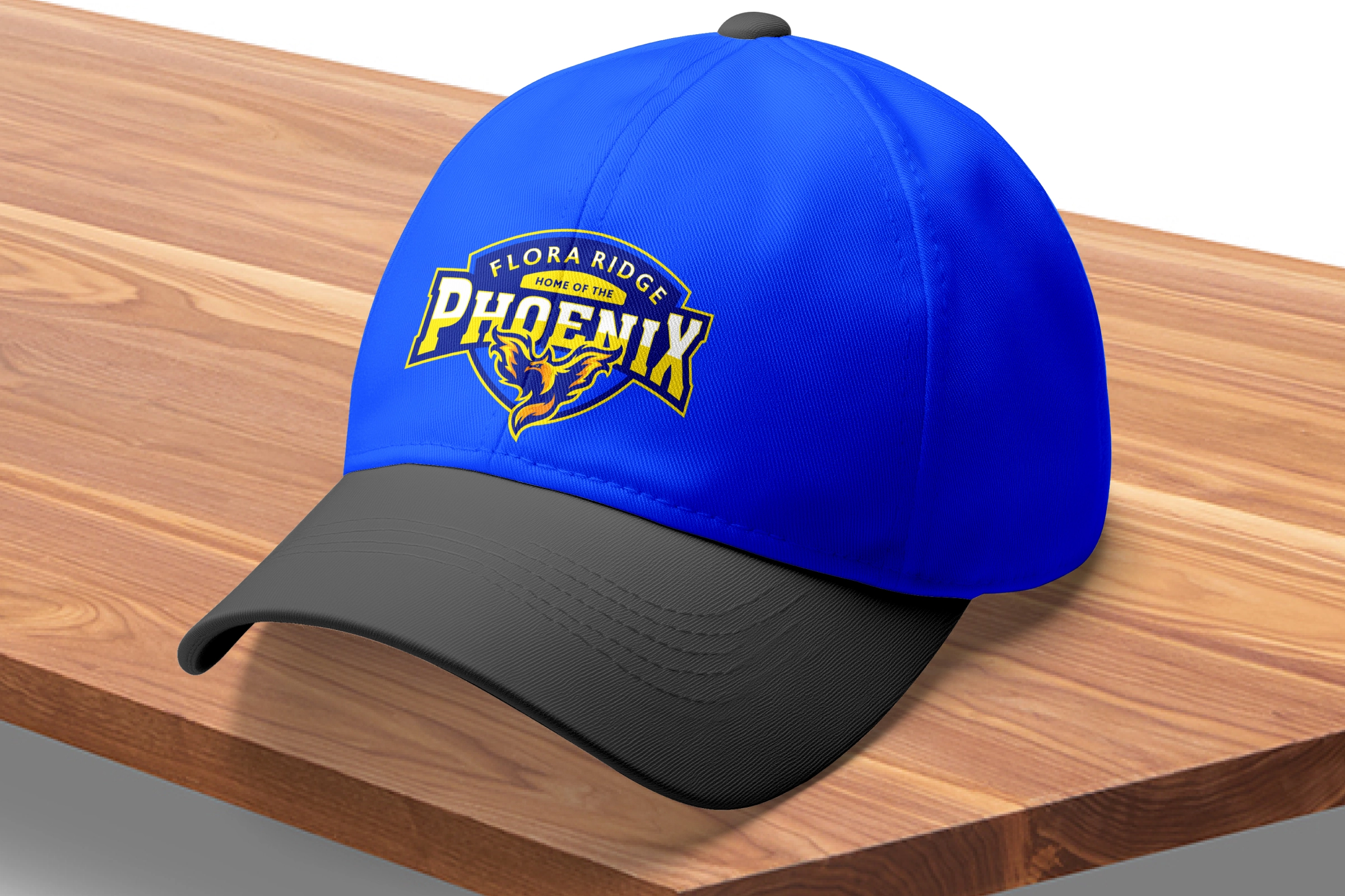Royal/black cap—embroidered Phoenix badge on royal crown with black bill; retail‑ready headwear concept