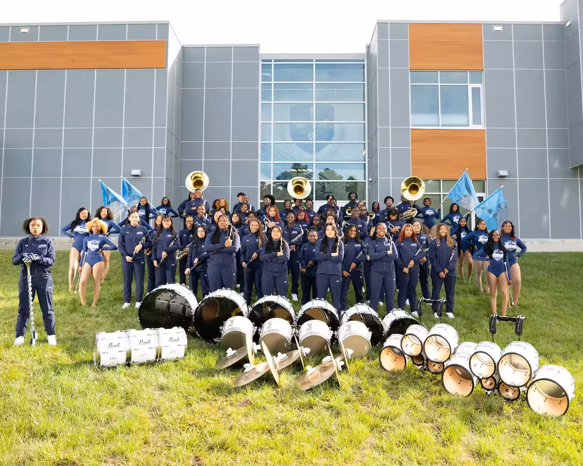 School enrollment promotional materials featuring diverse students in branded apparel with championship messaging