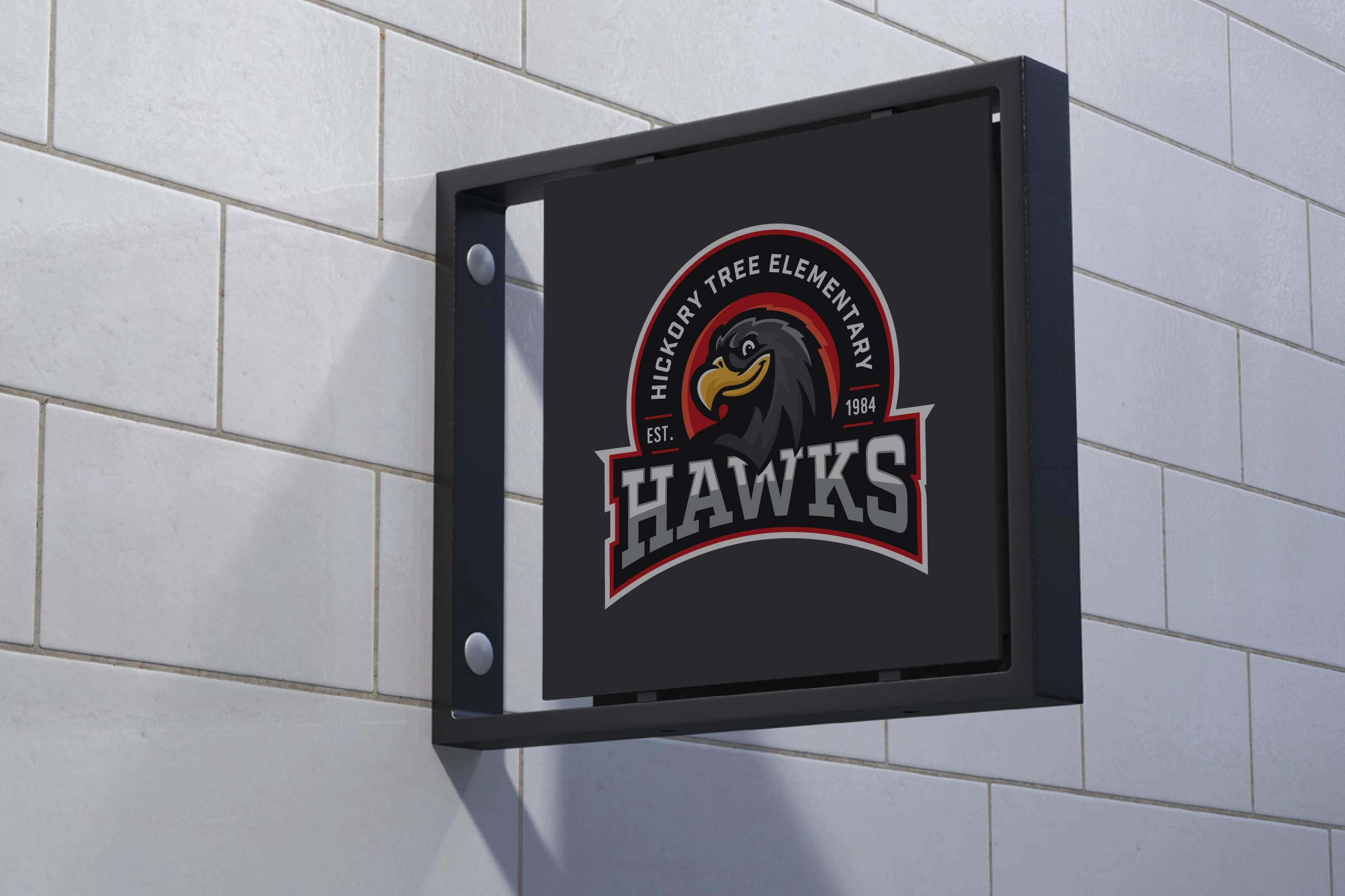 Interior blade sign—compact Hawks badge on dark panel for wayfinding