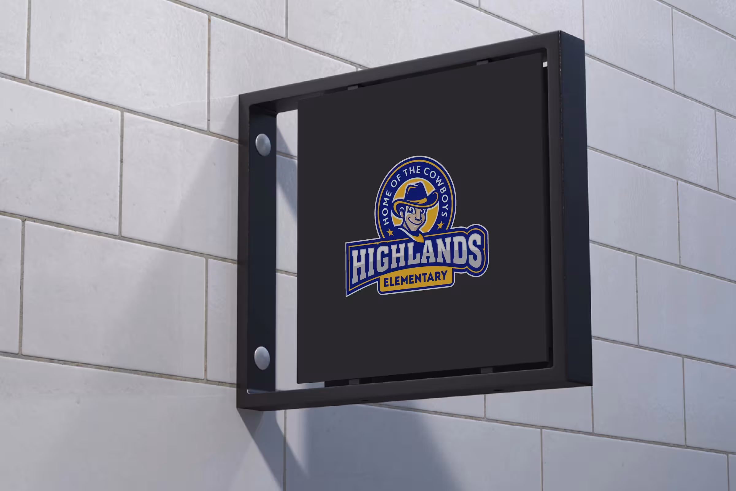 Interior blade sign—compact Cowboys badge on dark panel for wayfinding