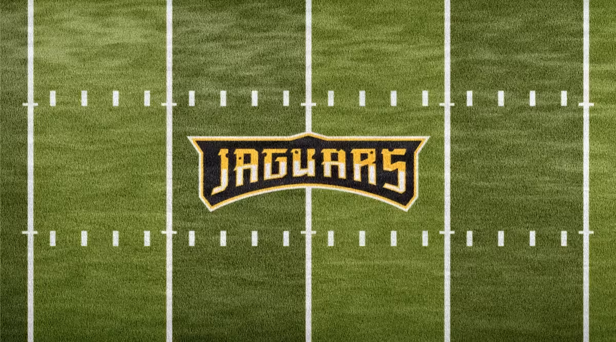 Close-up hero of jaguar head illustration and crest elements—showing expression, spot pattern and outline system on Championship Gold