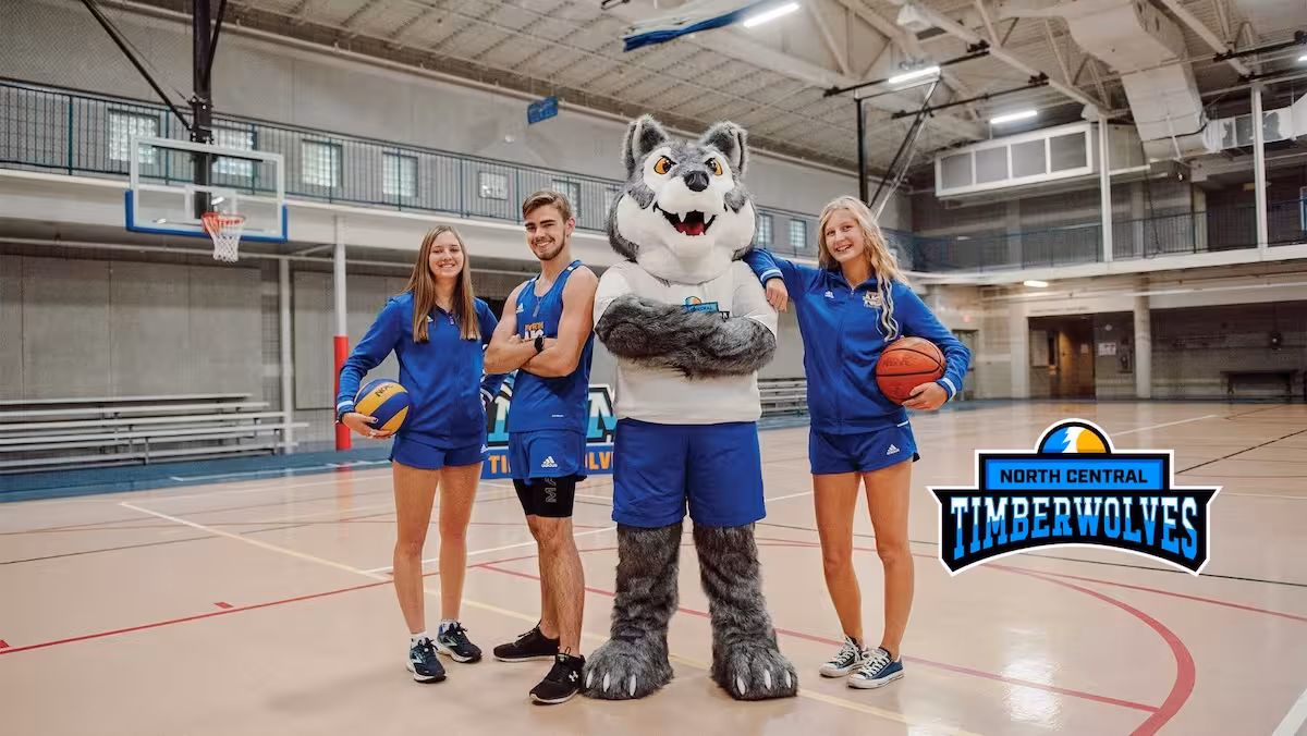 In‑gym activation: mascot suit with youth athletes and primary crest—real‑world usage that builds engagement